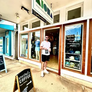 a man standing in front of a coffee shop