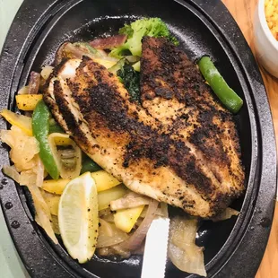 a plate of chicken and vegetables