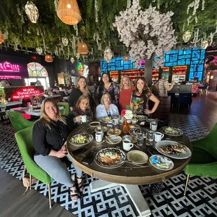 a group of people sitting around a table