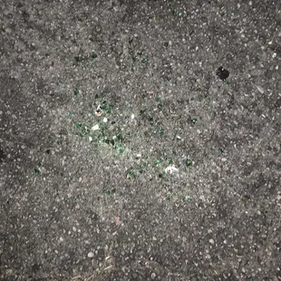 a broken glass bottle on the ground