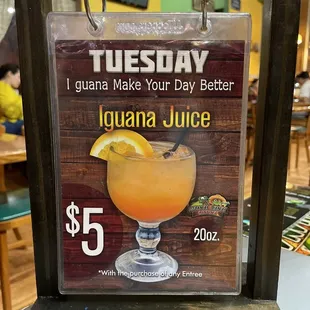 a sign for tuesday iguana juice