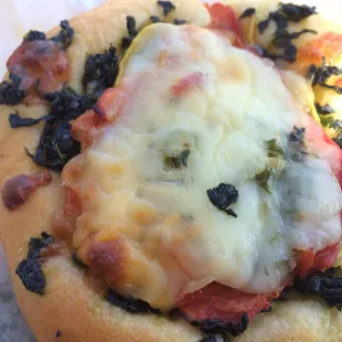 Veggie kolache- heavy spinach and squash under tomato... But very good