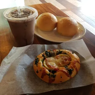 Spinach kolache, potato broccoli cheese and potato egg and cheese kolaches with iced mocha