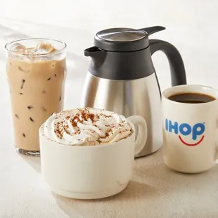 two cups of coffee and a coffee pot