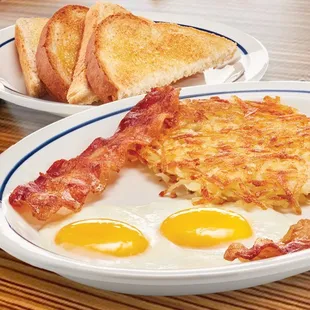 a plate of eggs, bacon and toast