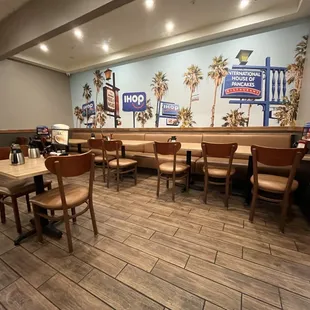 the interior of a restaurant with tables and chairs