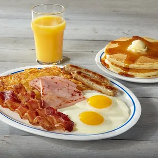 a breakfast of pancakes, bacon and eggs