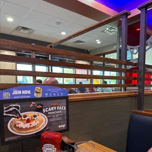 a woman sitting at a table in a restaurant