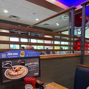 a woman sitting at a table in a restaurant