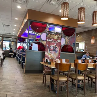 the inside of a restaurant with tables and chairs
