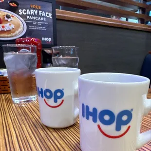 two coffee mugs sitting on a table