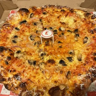Pizza we ordered. We ordered a mushroom and scallion pizza. We would have liked a little more cheese so next time we will order extra.