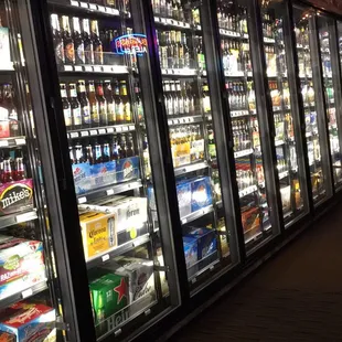 a row of beer coolers in a grocery store