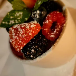 a dessert with berries and powdered sugar