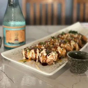 The Sushi Pizza
w/ crunchy rice cracked underneath and spicy salmon on top, topped w/ mango sauce and unagi sauce