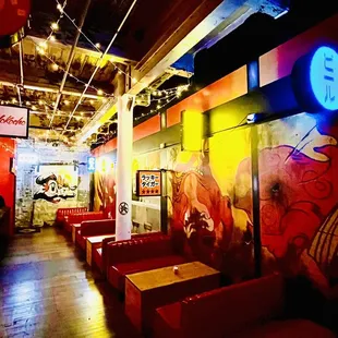 a brightly lit restaurant with red booths
