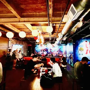people sitting at tables in a restaurant
