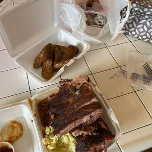 Ribs, sausage, potato salad, boudin, baked beans, and the fixins