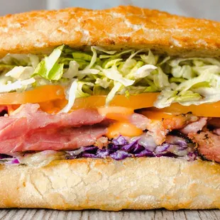 a sub sandwich with meat and coleslaw