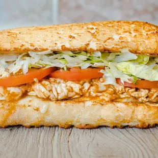 a chicken sandwich with lettuce and tomatoes