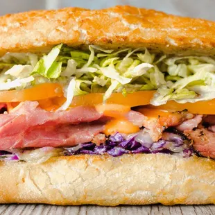 a sub sandwich with meat and coleslaw