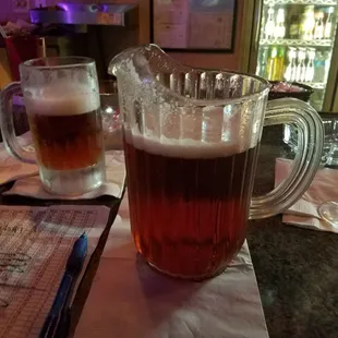 a pitcher of beer and a glass of beer