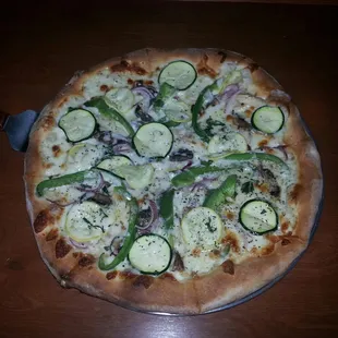 Pizza primavera. Alfredo sauce, zucchini, squash, peppers, mushrooms and grilled chicken.