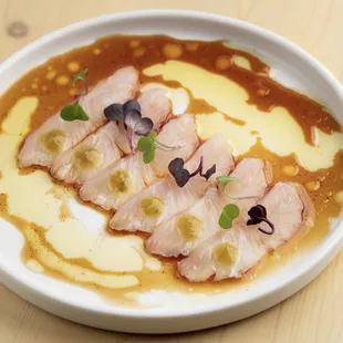 Kampachi carpaccio: local kampachi sashimi, yuzu kosho, ponzu vinaigrette.