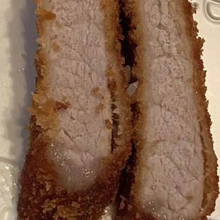 Tonkatsu has no air pocket in between the breading and pork meat.