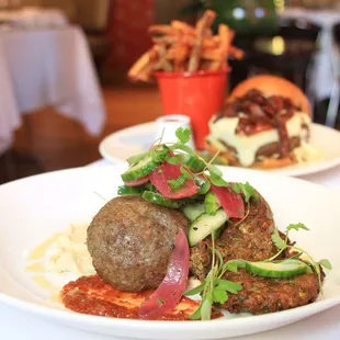 Lamb meatball with crispy zucchini fritters and cucumber salad.