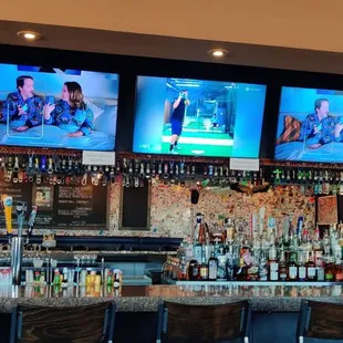 a bar with multiple televisions