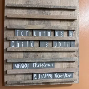 a wooden sign with words on it