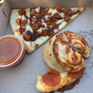 two slices of pizza and sauce