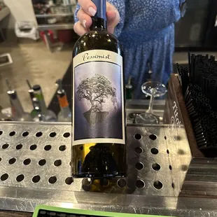 a woman holding a bottle of wine