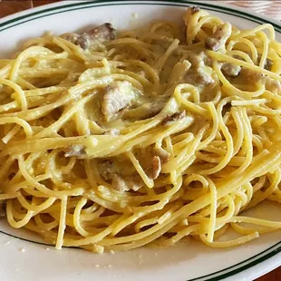 a plate of pasta with meat and cheese