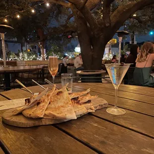a plate of pita chips and a glass of wine