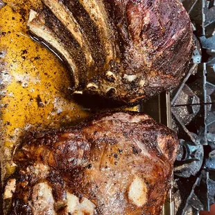 a pan of meat on a grill