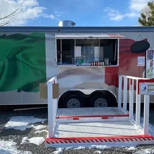 a food truck with a flag on it