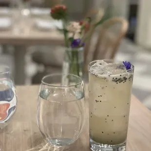 a glass of water and a drink on a table