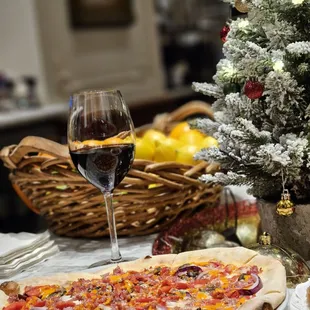 a pizza and a glass of wine