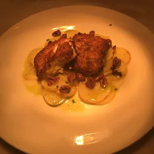 Merluzzo alla Riviera - Grilled black cod with pine nut, basil and pecorino crust; served with Ligurian potatoes and Taggiasche olives