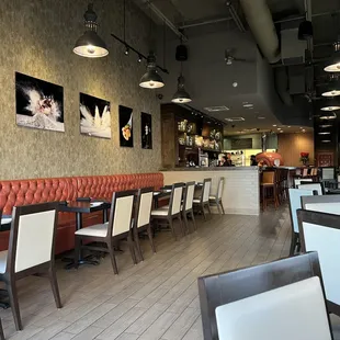 a dining area with tables and chairs