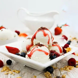 a bowl of ice cream and berries