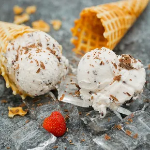 two cones of ice cream and a strawberry