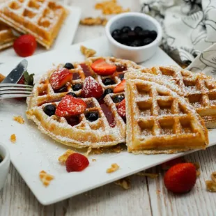 a waffle with strawberries and blueberries