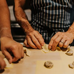 a man&apos;s hands preparing food