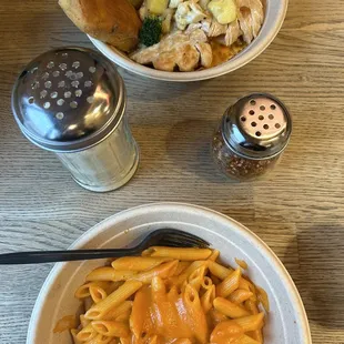 a bowl of pasta and a plate of vegetables