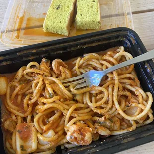 a plate of spaghetti and bread