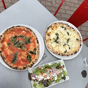 two pizzas and a salad