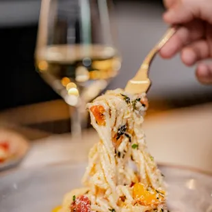 Spaghetti featuring house made pasta with sun gold tomatoes.